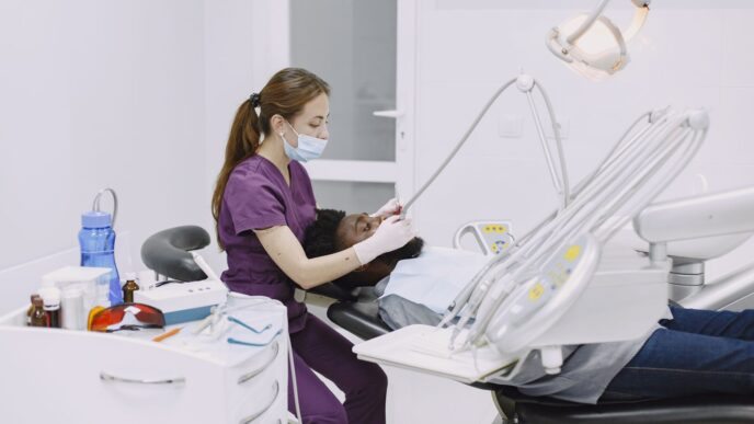 A patient in a dental chair during a checkup, illustrating dental insurance annual maximum planning
