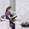 A patient in a dental chair during a checkup, illustrating dental insurance annual maximum planning