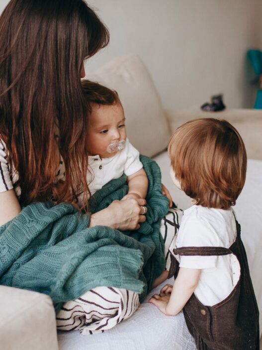 A family at home, illustrating how to compare dependent health coverage across two employer plans