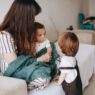 A family at home, illustrating how to compare dependent health coverage across two employer plans