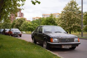 An older sedan parked along a residential street