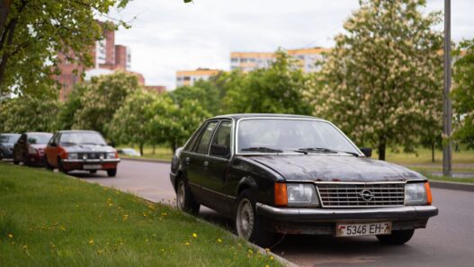 An older sedan parked along a residential street