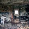Fire-damaged home interior, illustrating how a low dwelling coverage amount reduces a partial loss payout