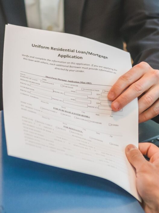 Student and parent filling out a financial aid application on a laptop at a kitchen table