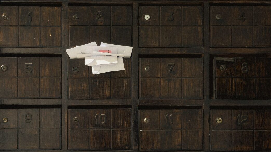 Unopened envelopes in a mailbox, illustrating unclaimed money held by states