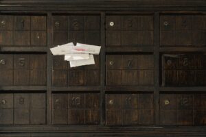 Unopened envelopes in a mailbox, illustrating unclaimed money held by states