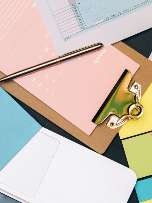 Person paying monthly bills with a calendar, illustrating getting one month ahead on bills