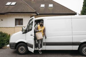 Fuel delivery truck refilling a home heating oil tank in winter