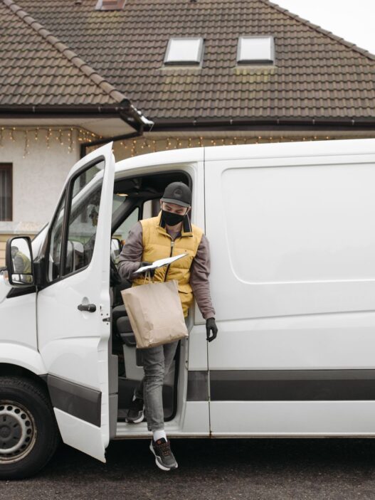 Fuel delivery truck refilling a home heating oil tank in winter