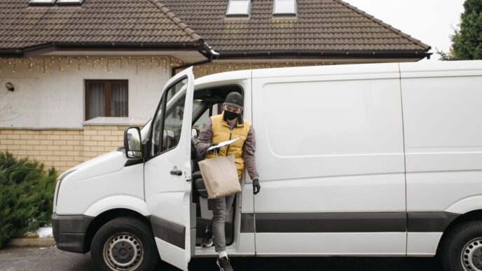 Fuel delivery truck refilling a home heating oil tank in winter