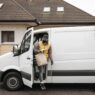 Fuel delivery truck refilling a home heating oil tank in winter