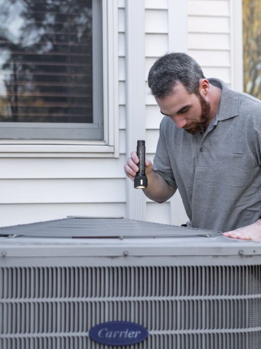 Technician servicing a home heating system