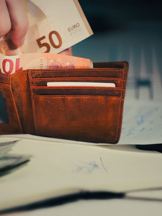 Bank statement and coins on a desk representing a forgotten inactive bank account