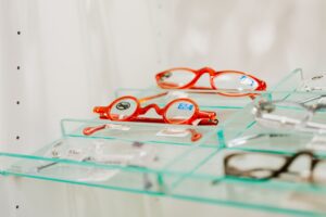 Rows of eyeglass frames on display at an optical shop