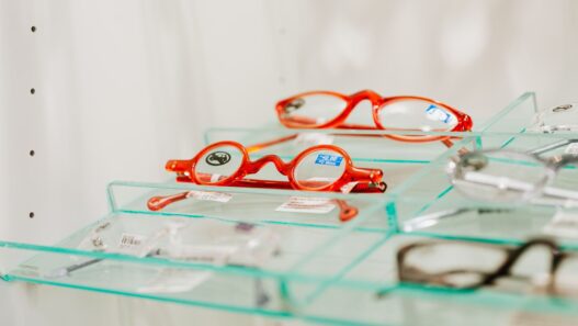 Rows of eyeglass frames on display at an optical shop