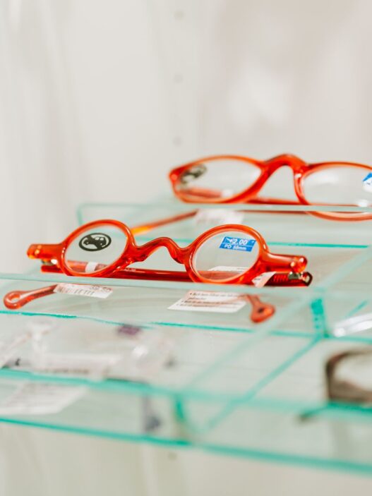 Rows of eyeglass frames on display at an optical shop