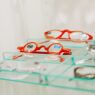 Rows of eyeglass frames on display at an optical shop