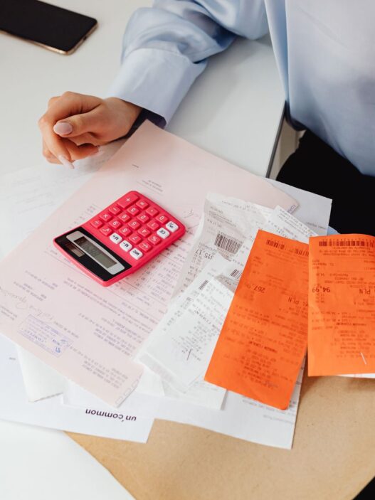 Medical billing paperwork and a calculator, illustrating tracking an out-of-pocket maximum