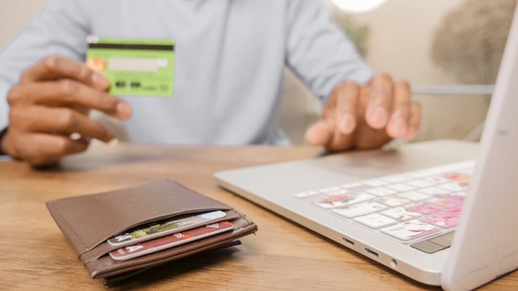 Person holding a prepaid debit card and wallet