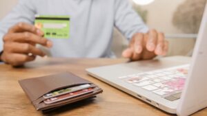 Person holding a prepaid debit card and wallet