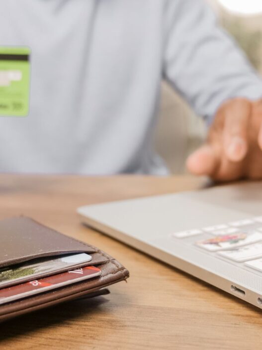 Person holding a prepaid debit card and wallet