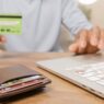Person holding a prepaid debit card and wallet