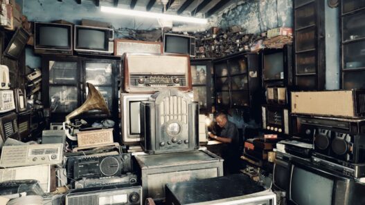 Shopper comparing television prices in an electronics store during a holiday sale