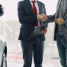 Car keys resting on a signed auto loan contract at a dealership desk
