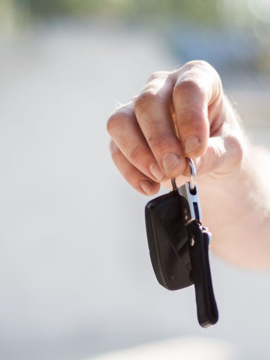 A rental car counter with keys on the desk, illustrating rental car insurance coverage decisions