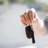 A rental car counter with keys on the desk, illustrating rental car insurance coverage decisions