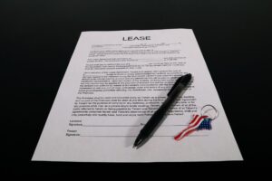 Renter reviewing a lease and rent paperwork at a kitchen table