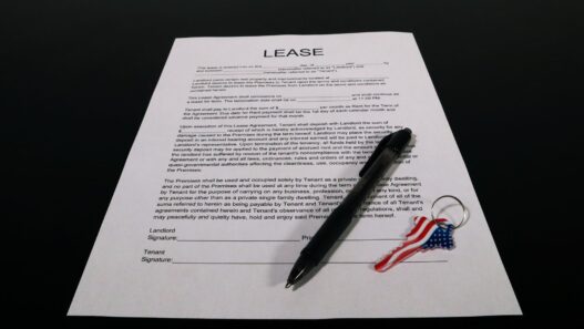 Renter reviewing a lease and rent paperwork at a kitchen table