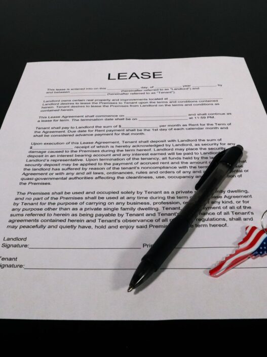 Renter reviewing a lease and rent paperwork at a kitchen table