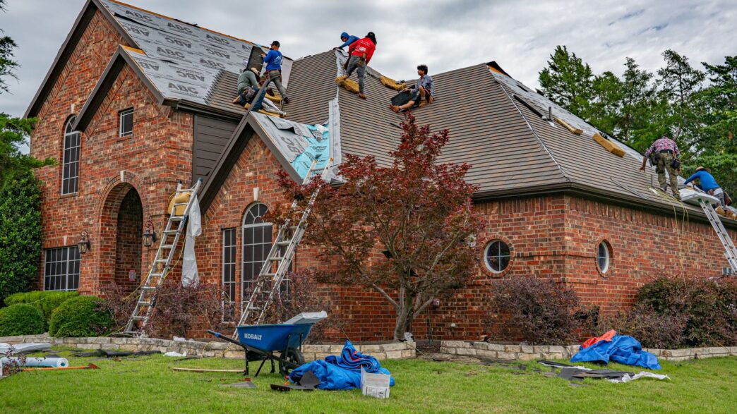 Asphalt shingle roof being inspected for hail damage, illustrating roof actual cash value settlements