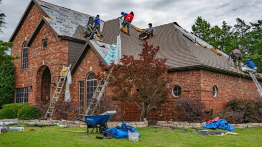 Asphalt shingle roof being inspected for hail damage, illustrating roof actual cash value settlements