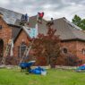 Asphalt shingle roof being inspected for hail damage, illustrating roof actual cash value settlements