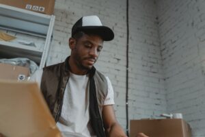 Seasonal warehouse worker sorting packages during a holiday shift