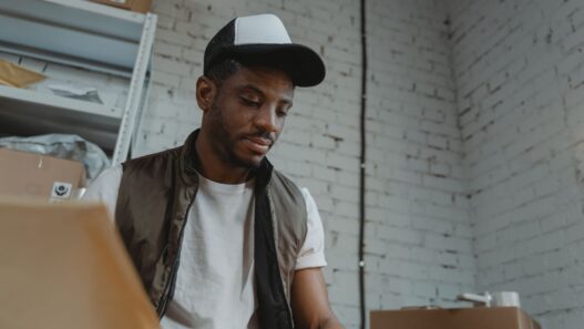 Seasonal warehouse worker sorting packages during a holiday shift