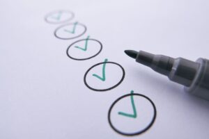 Person writing a paper check from a checkbook