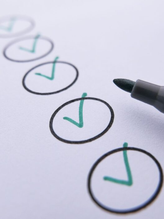Person writing a paper check from a checkbook