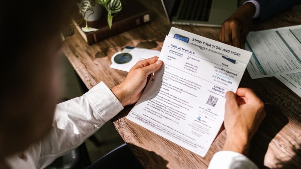 Person reviewing a credit report on a laptop at home