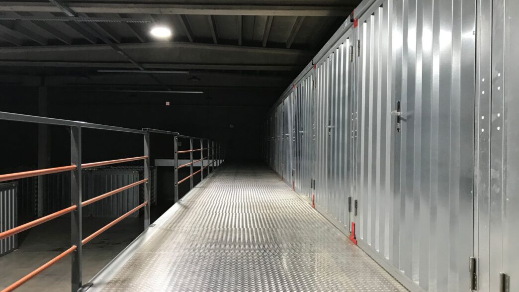 Row of self storage unit doors along an indoor facility hallway