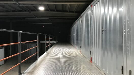 Row of self storage unit doors along an indoor facility hallway