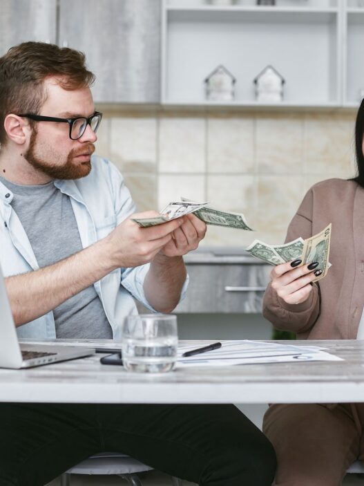 A young family reviewing household finances and insurance paperwork at home