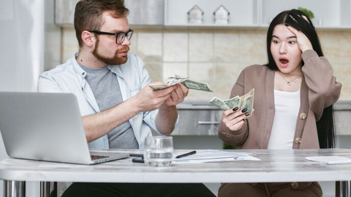 A young family reviewing household finances and insurance paperwork at home