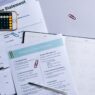 A monthly calendar and notebook used for planning a household budget