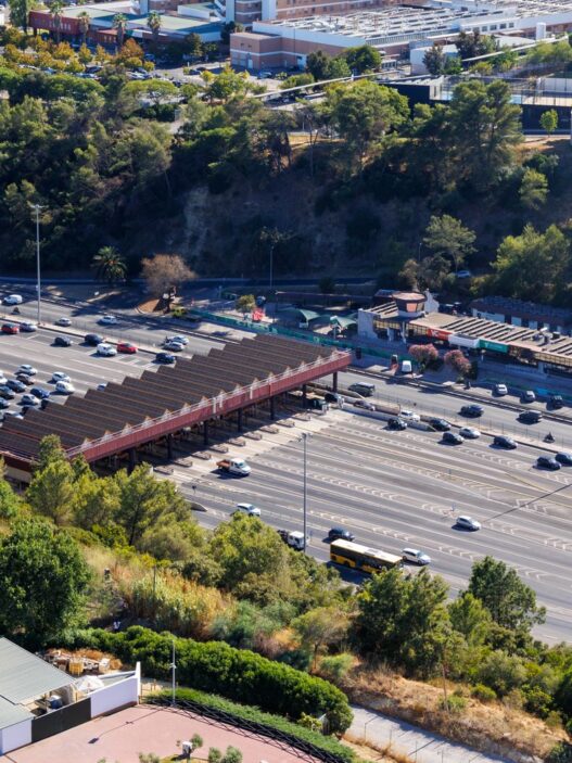 Cars passing under an electronic toll gantry on a highway