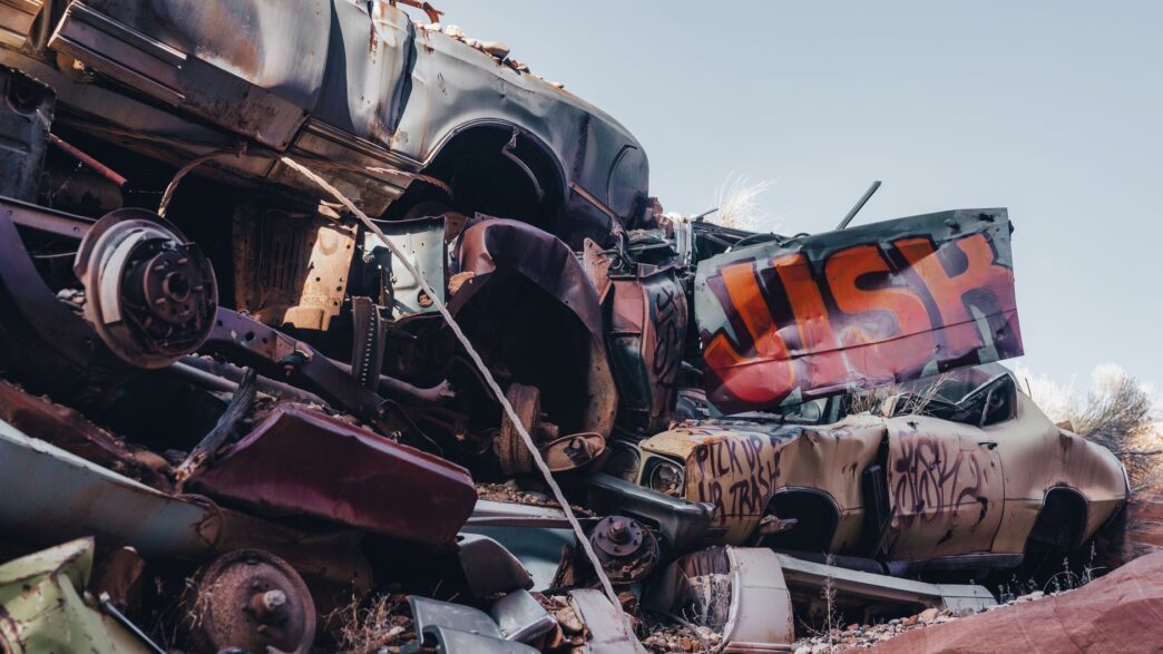 A wrecked vehicle in a salvage yard, illustrating how insurers calculate a total loss settlement