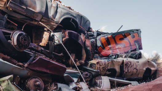 A wrecked vehicle in a salvage yard, illustrating how insurers calculate a total loss settlement