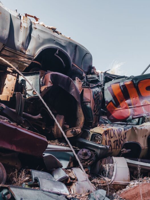 A wrecked vehicle in a salvage yard, illustrating how insurers calculate a total loss settlement
